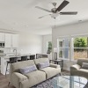 living room with sofa and white kitchen with stainless appliances  at Kindrey Townhomes