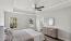 large primary bedroom with a bed and ceiling fan